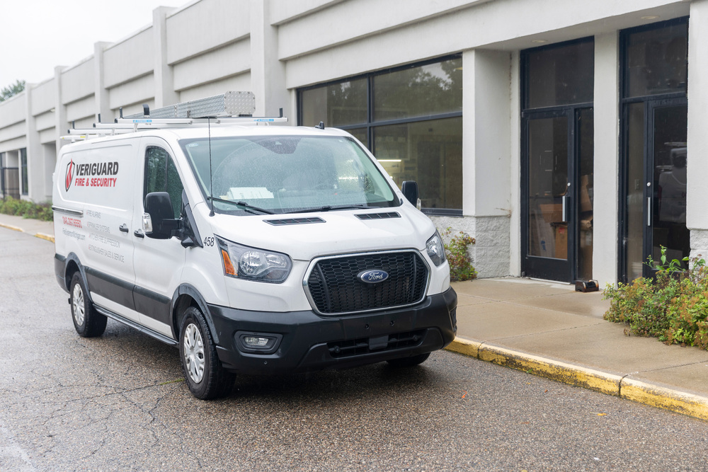 Veriguard Fire & Security service van parked outside a commercial building
