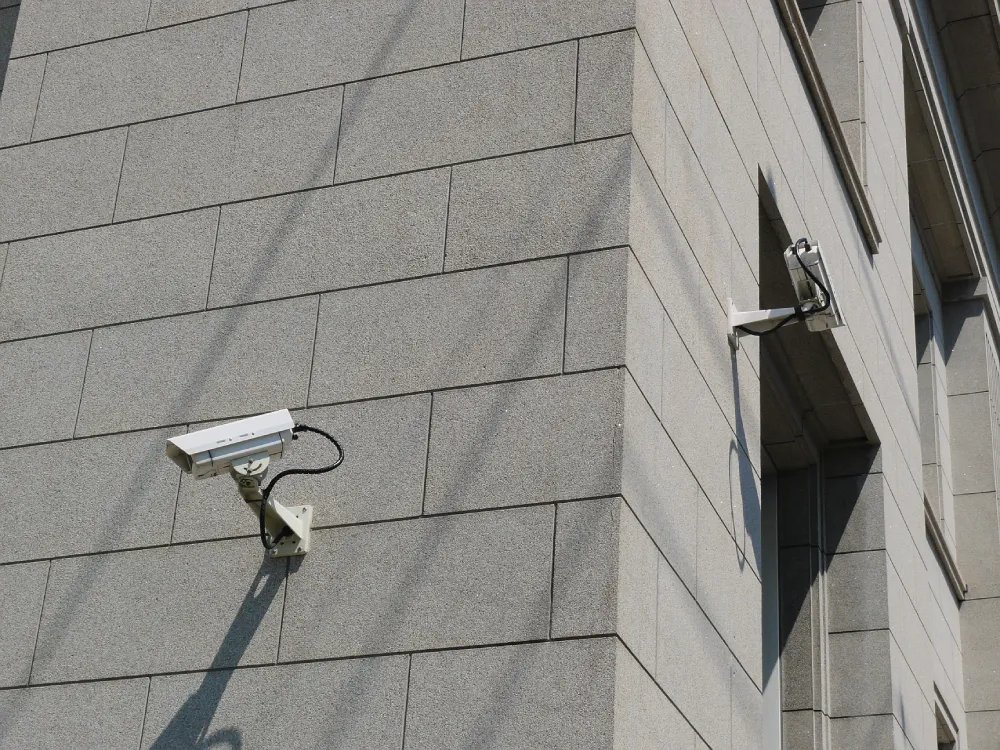 Security camera mounted on the exterior wall of a building