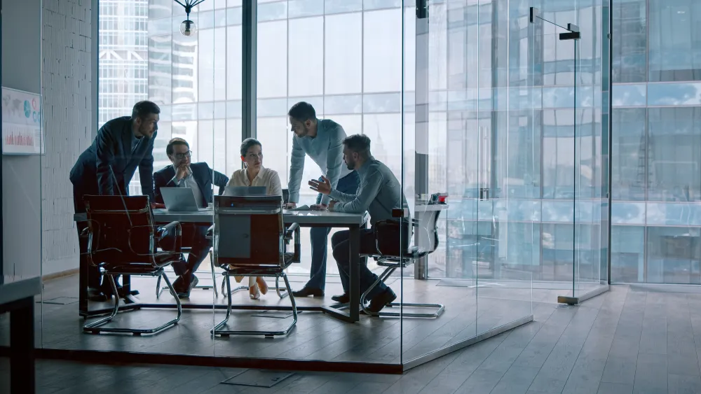 Business team meeting in a glass-walled conference room