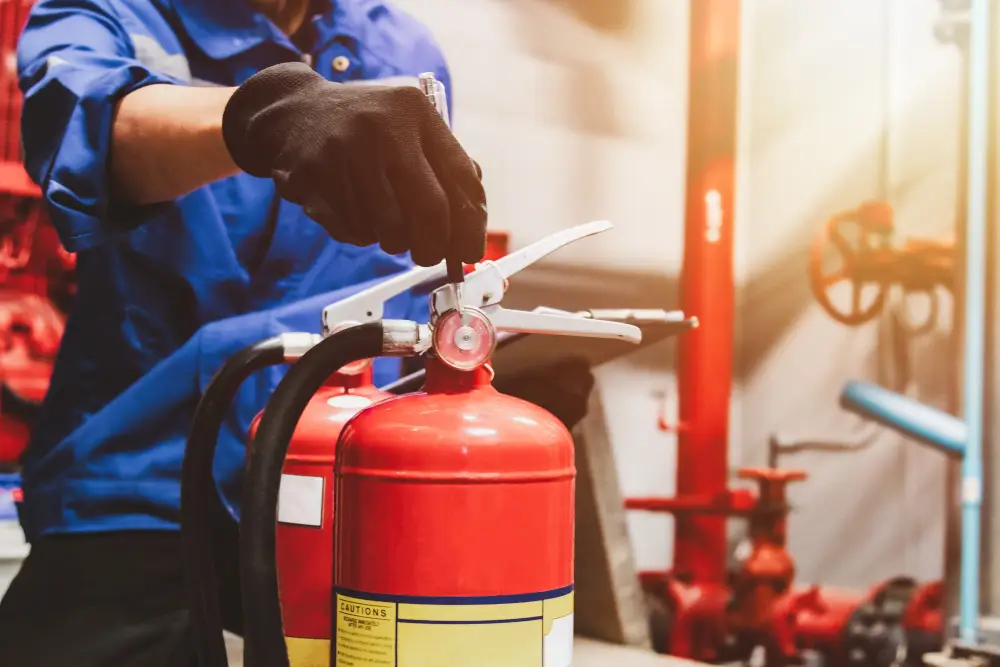 Technician in gloves servicing a fire extinguisher
