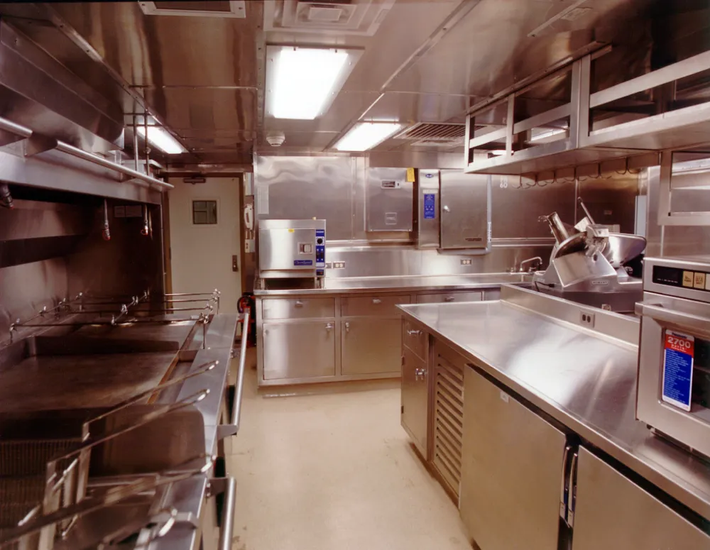 Stainless steel ship galley kitchen with an R-102 fire suppression system installed