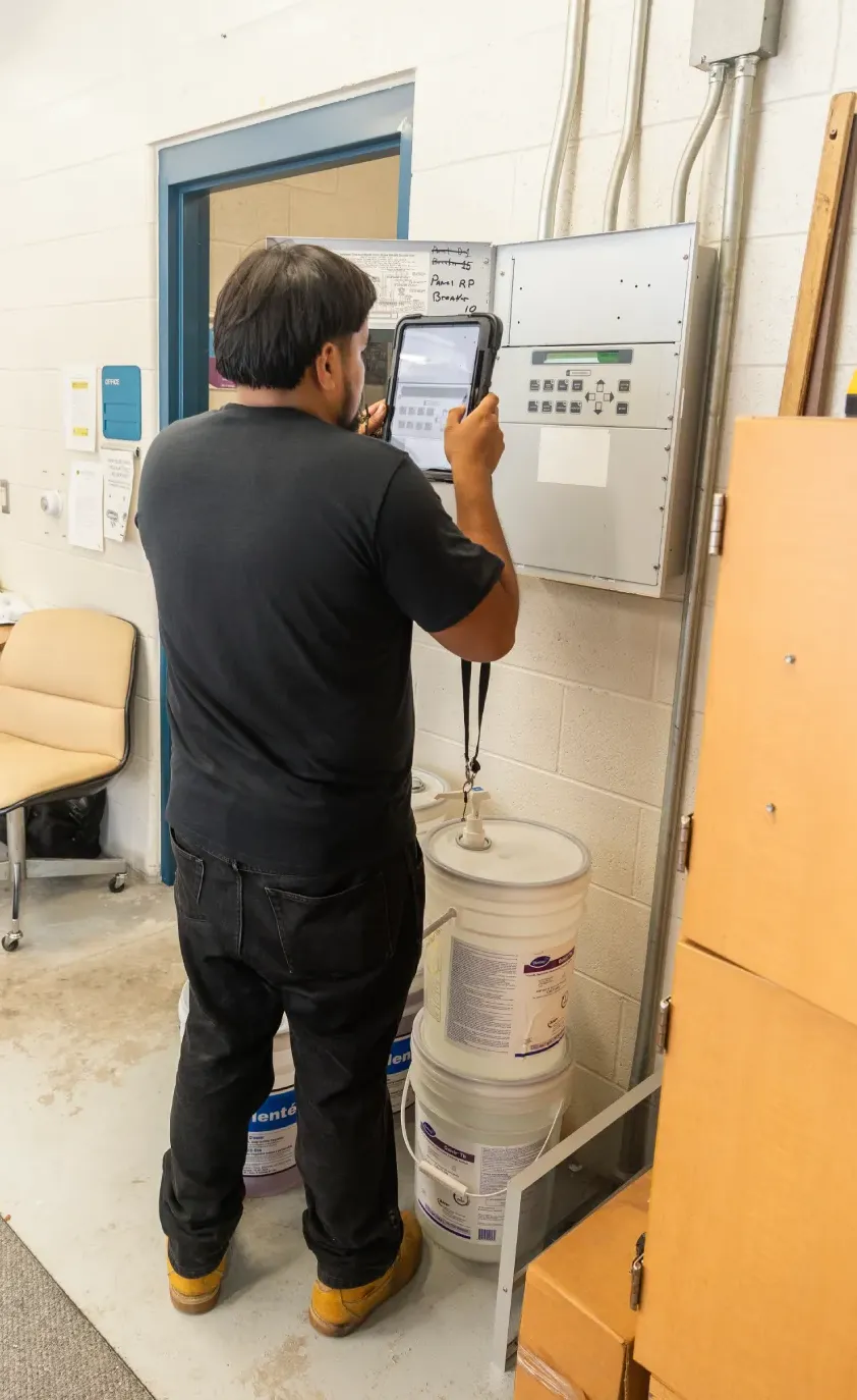 Technician using a tablet to document an inspection in a commercial building
